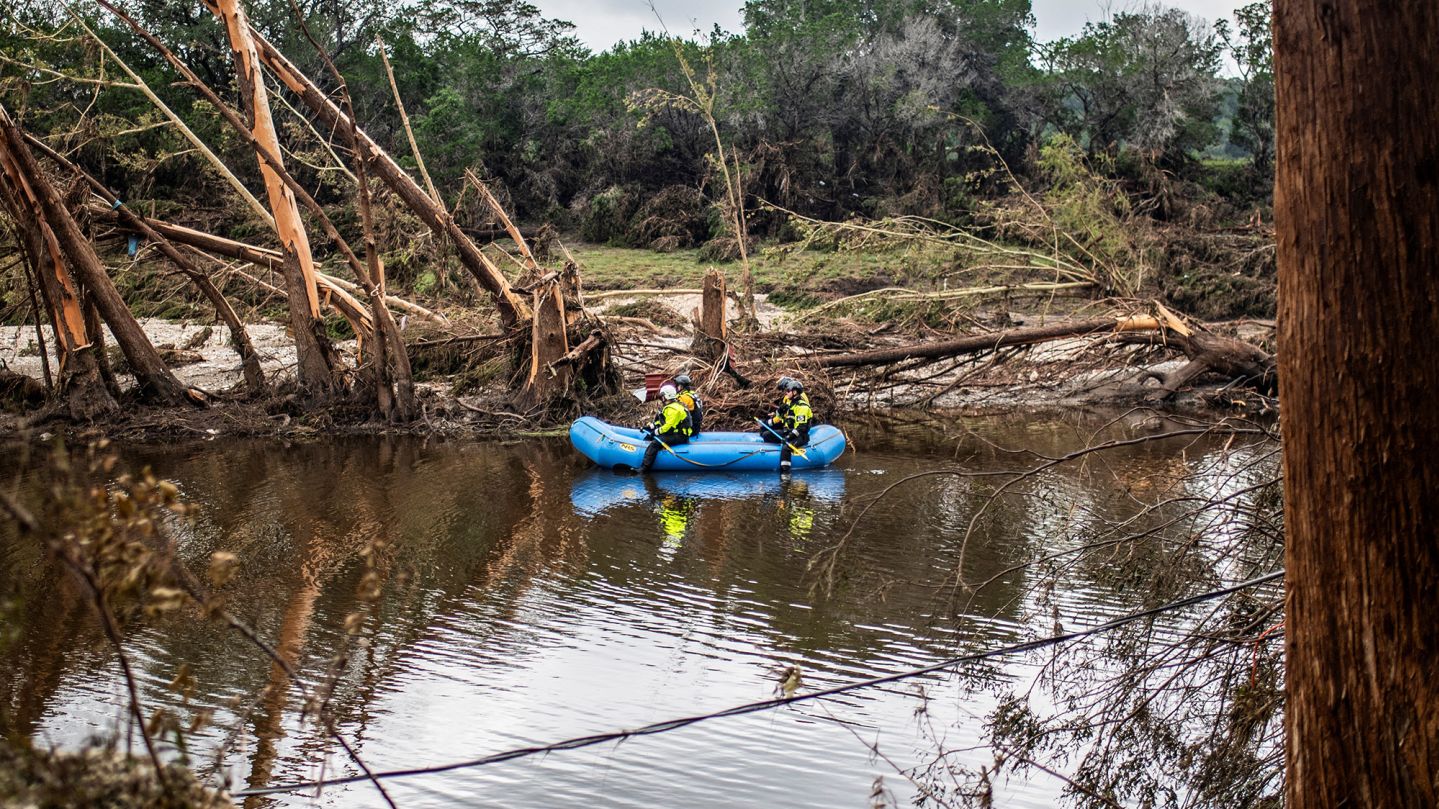 A group of search and rescue workers paddle a boat in the Guadalupe River in the aftermath of deadly flooding in Kerr County, Texas, U.S., July 7, 2025.   REUTERS/Sergio Flores