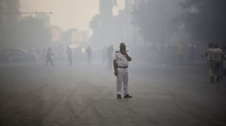 A policeman looks on during the extinguishing of a fire that broke out in a telecommunications building, which led to communications disruptions across the Egyptian capital, including people being unable to make phone calls, according to local media, in Cairo, Egypt, July 7, 2025.