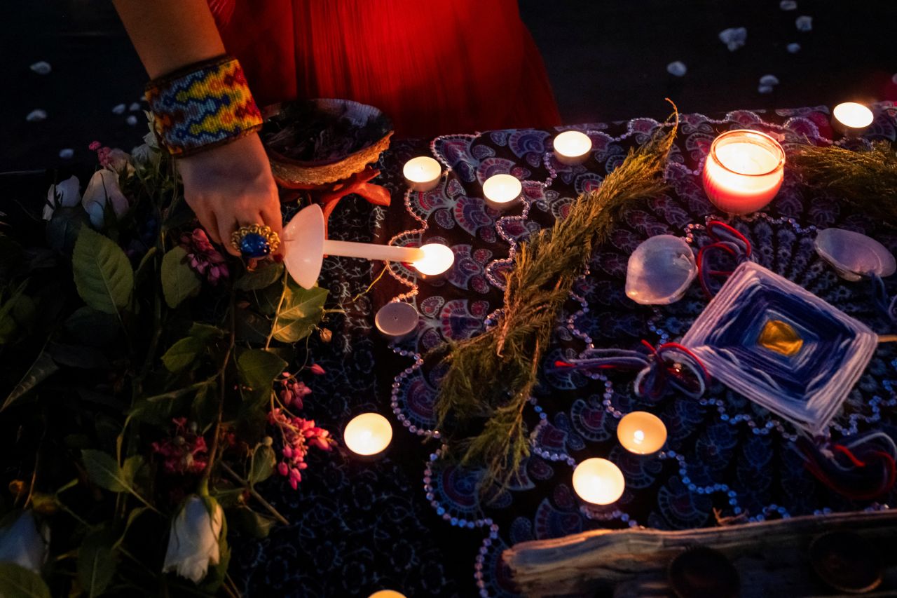 A woman lights candles during a vigil in memory of Texas flooding victims, on Monday.