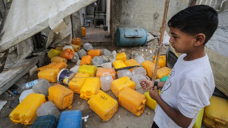 A young boy inspects the site of an Israeli strike that killed Palestinians gathered at a water distribution point, according to medics, in central Gaza on July 13.