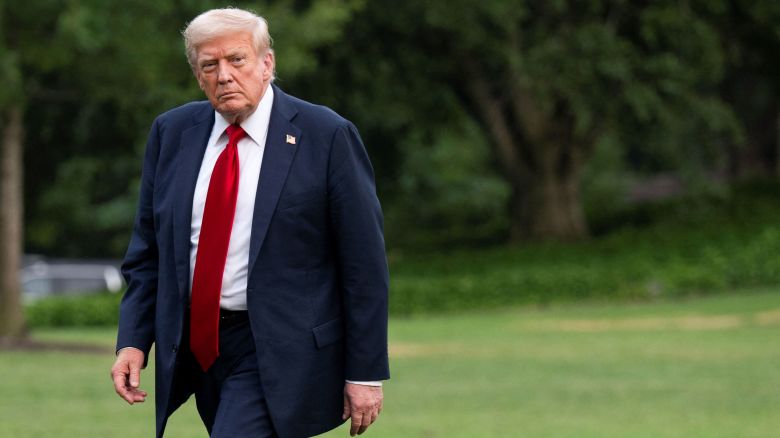 U.S. President Donald Trump walks on the South Lawn as he arrives at the White House.
