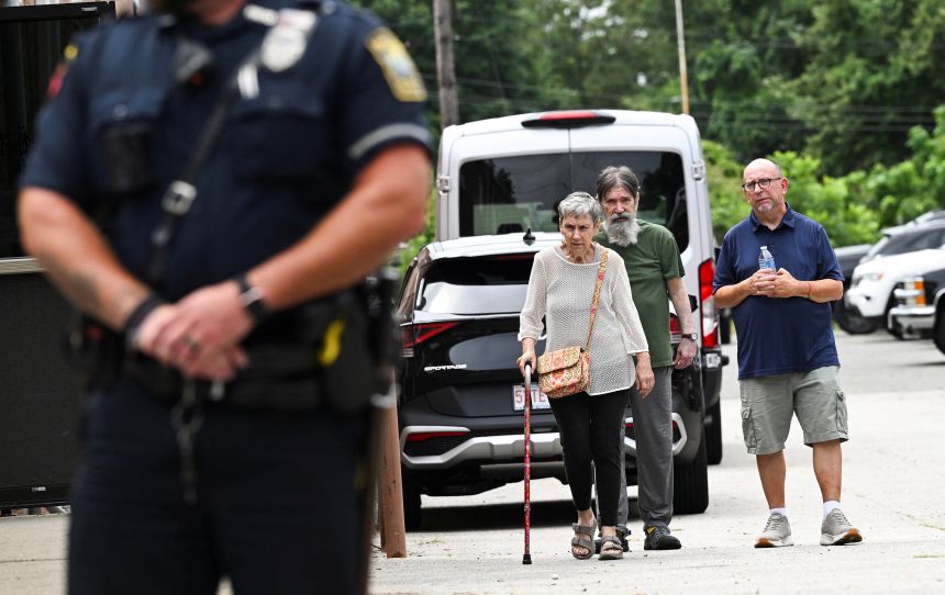 Residents of Gabriel House Assisted Living Facility make their way to an emergency shelter set up at the Timao Center, after a deadly fire broke out in Fall River, Massachusetts, on Monday.
