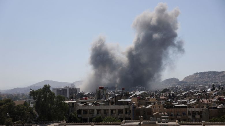 Smoke rises after strikes on Syria's defense ministry in Damascus, according to Al Jazeera TV, in Damascus, Syria July 16, 2025. REUTERS/Khalil Ashawi 