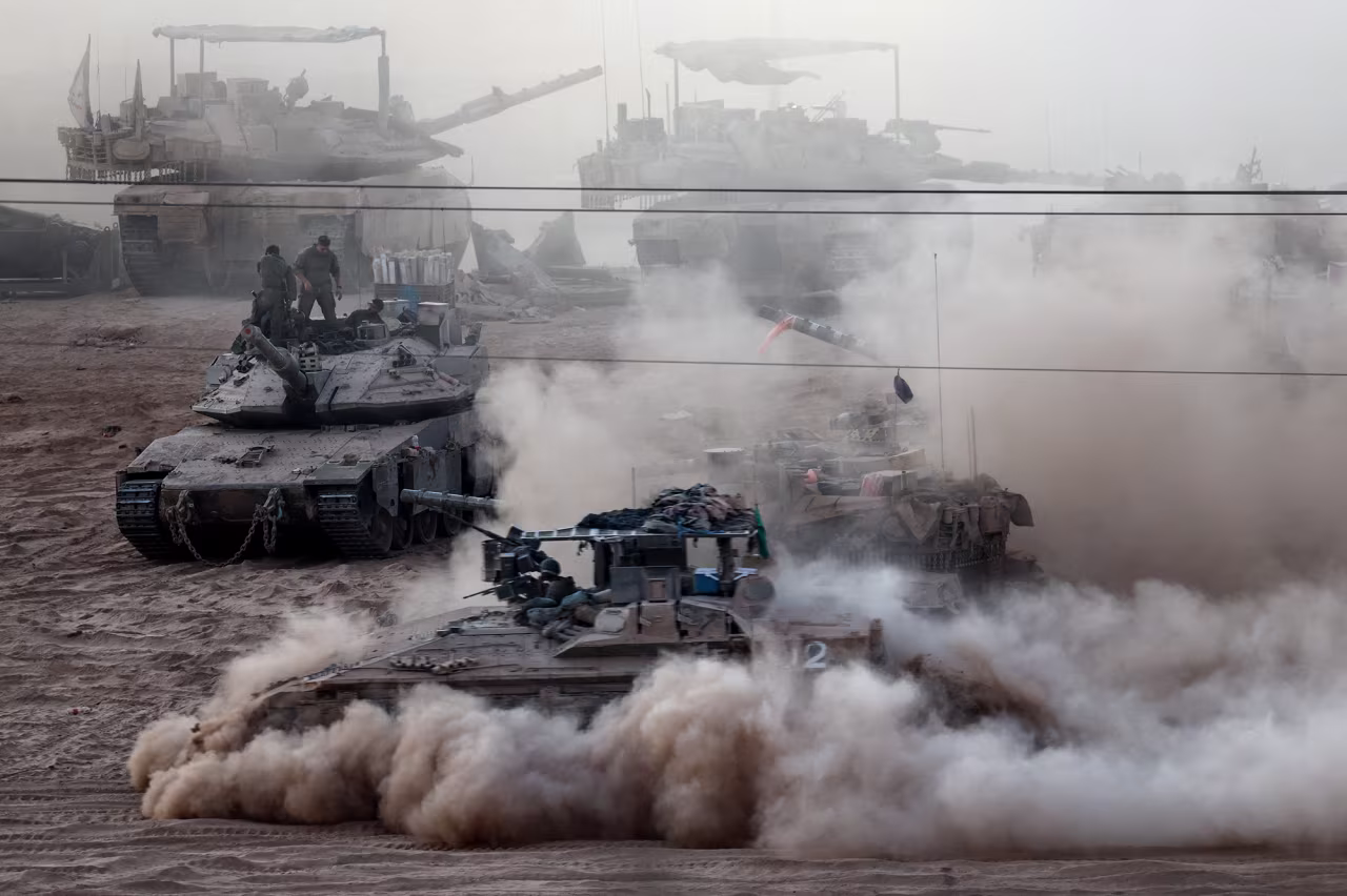 An Israeli APC manoeuvres next to other military vehicles on the Israeli side of the Israel-Gaza border, on July 16.