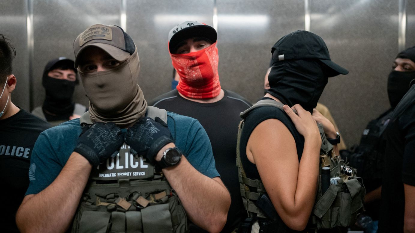 Federal immigration officers take the elevator at immigration court in Manhattan on July 17.