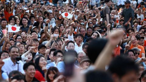 Sanseito party supporters raise their fists during the Sanseito's election campaign tour, on the last day of campaigning for the July 20 upper house election, at Shiba Park in Tokyo, Japan July 19, 2025.