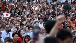 Sanseito party supporters raise their fists during the Sanseito's election campaign tour, on the last day of campaigning for the July 20 upper house election, at Shiba Park in Tokyo, Japan July 19, 2025.