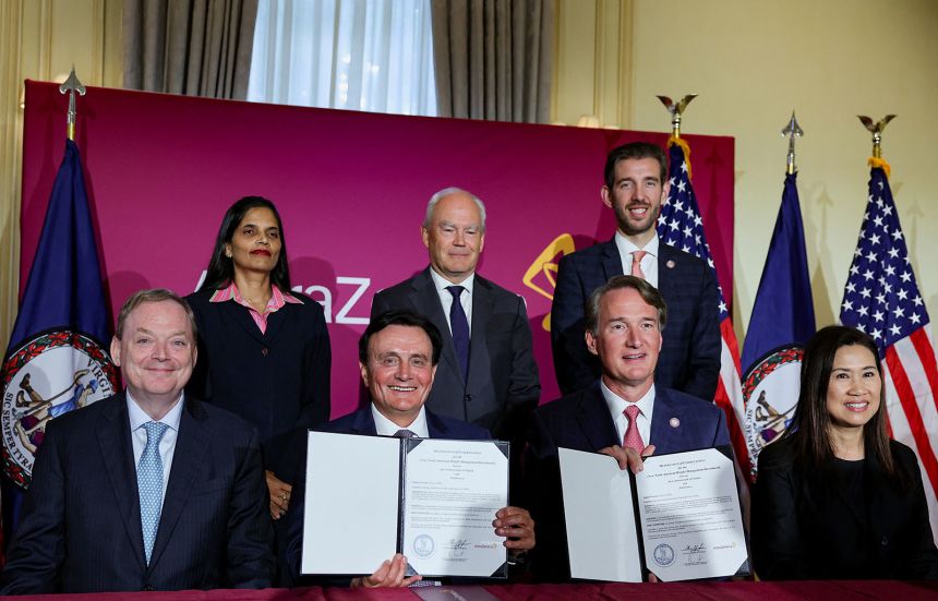 National Economic Council Director Kevin Hassett and Virginia Governor Glenn Youngkin celebrate AstraZeneca's manufacturing investment in the state with the drug company's executives in July.
