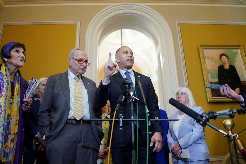 House Minority Leader Hakeem Jeffries speaks next to Senate Minority Leader Chuck Schumer during a press conference at the US Capitol on July 22.