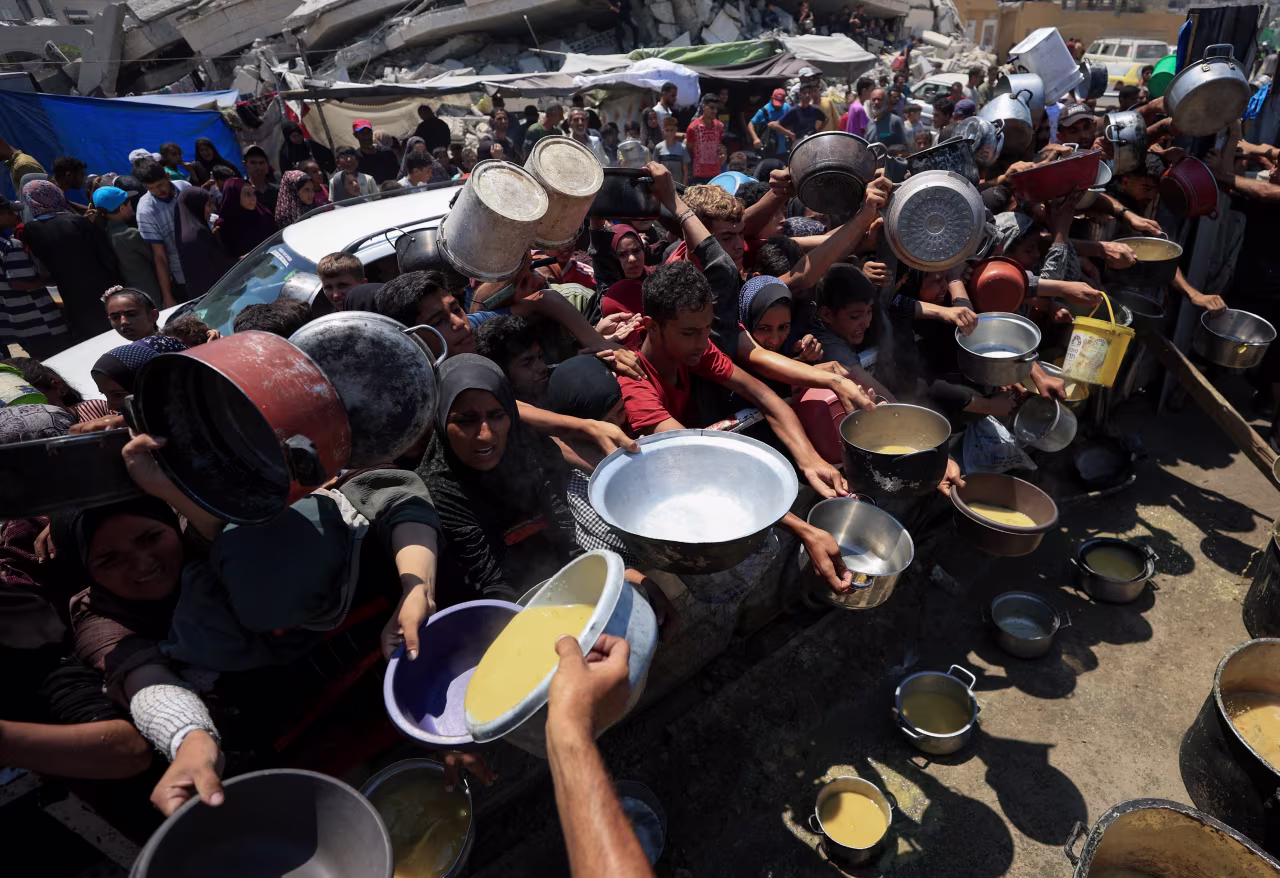 Palestinians gather to receive food from a charity kitchen in Gaza City.