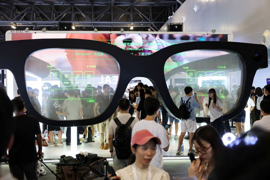 People visit a Rokid booth during the World Artificial Intelligence Conference in Shanghai, China July 26, 2025.