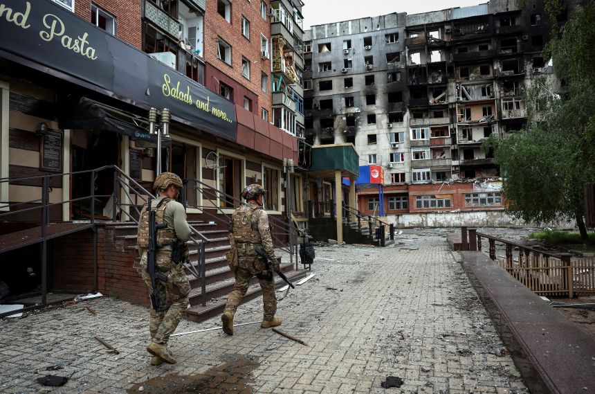 Ukrainian police officers check an area for residents to evacuate in the frontline town of Pokrovsk, under attack from Russian forces in Donetsk region, Ukraine, on May 21, 2025.