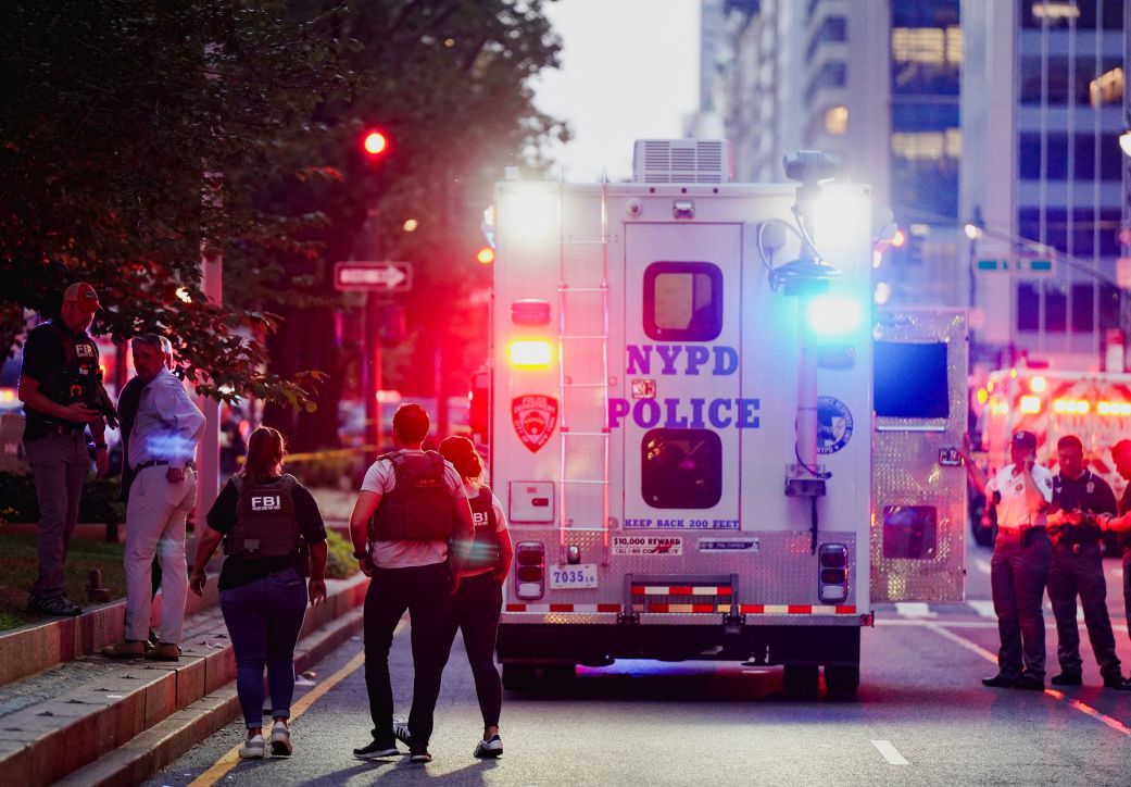 FBI agents investigate near a New York Police Department (NYPD) response vehicle near the scene of a reported shooter situation in Manhattan.