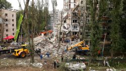 Emergency personnel work at the site of a partially collapsed apartment building hit during Russian missile and drone strikes, amid Russia's attack on Ukraine, in Kyiv, Ukraine July 31, 2025.