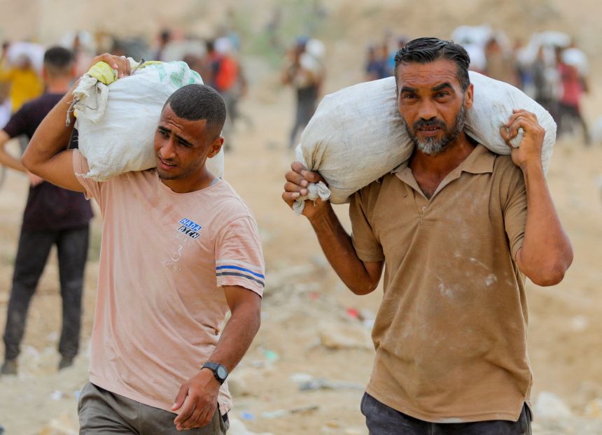 Palestinians carry aid supplies collected from the US-backed Gaza Humanitarian Foundation (GHF) in the central Gaza Strip on August 1.