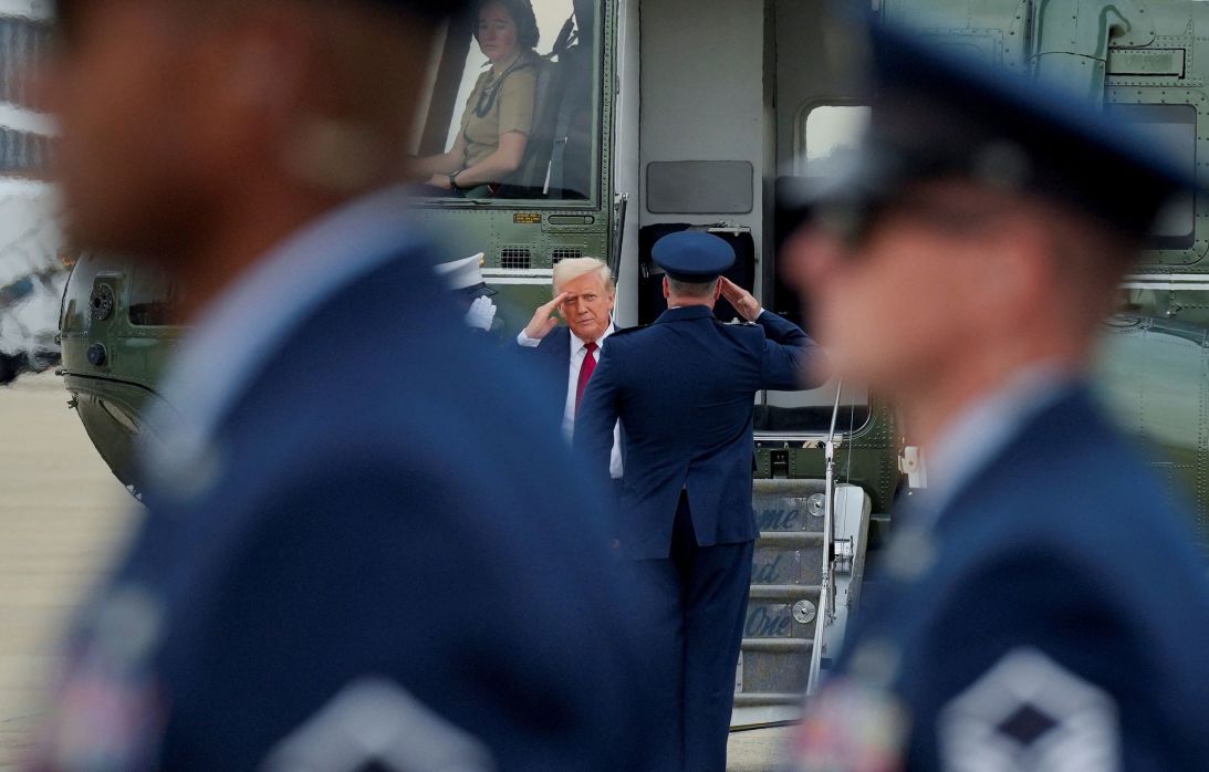 President Donald Trump salutes members of the military as he arrives to board Air Force One at Joint Base Andrews, Maryland, on August 1.