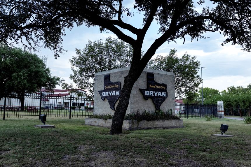 A tree shades the entrance to the Federal Prison Camp in Bryan, Texas, on Friday.
