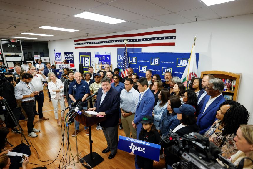Illinois Governor J.B. Pritzker speaks in front of Democratic lawmakers from Texas during a press conference, after they left their state to deny Republicans the quorum needed to redraw the state's 38 congressional districts, in Carol Stream, Illinois, on August 3, 2025.