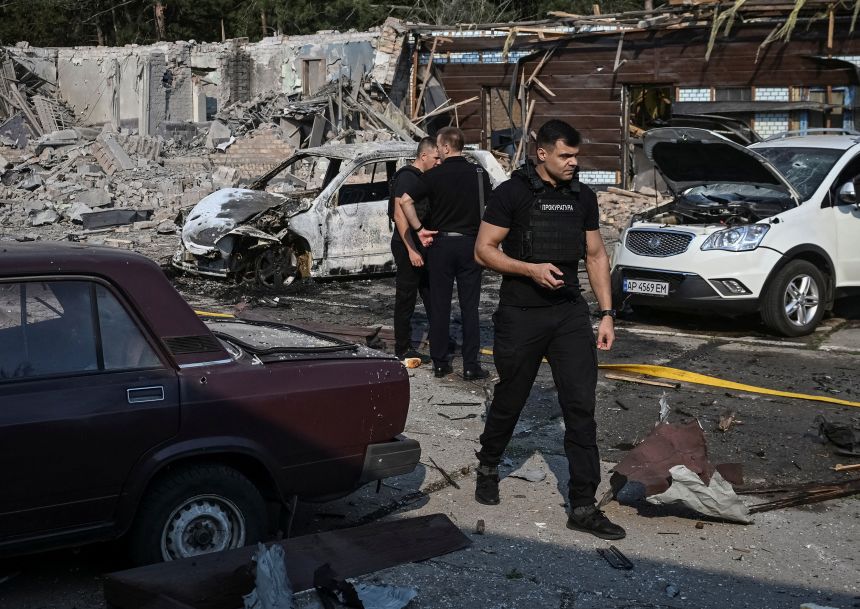 Prosecutors work at the site of a Russian strike in Zaporizhzhia, Ukraine on August 6, 2025. At least two people died and 12 more were injured in the attack, according to Ukrainian President Volodymyr Zelensky.