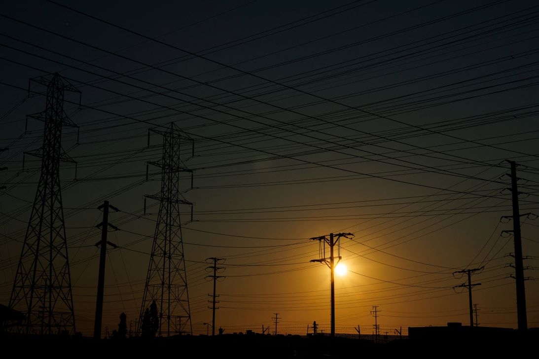 Electrical transmission towers and lines are shown in the early morning of a hot summer day in Commerce, California, on August 7.