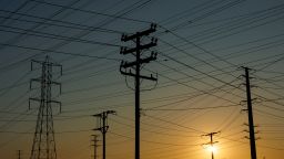 Electrical transmission towers, poles and lines are shown in the early morning of a hot summer day in Commerce, California, U.S, August 7, 2025.
