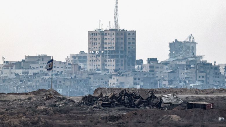 A damaged Israeli flag stands in Gaza, as seen from the Israeli side of the border on Thursday.