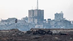 A damaged Israeli flag stands in Gaza, as seen from the Israeli side of the border on Thursday.