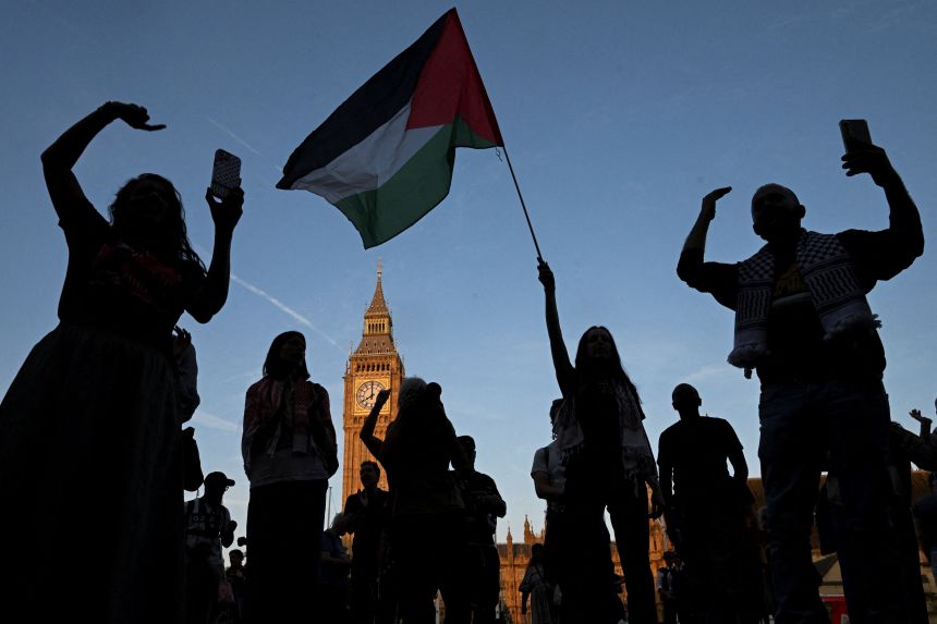 A woman holds a Palestinian flag as demonstrators attend a rally challenging the British government's proscription of "Palestine Action" under anti-terrorism laws in London on August 9, 2025.