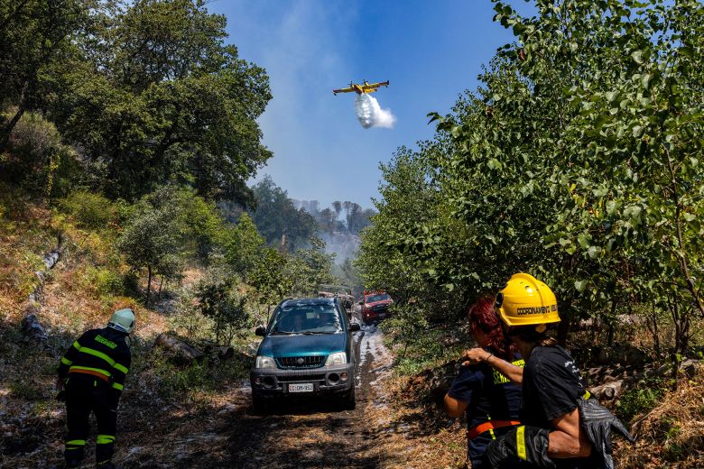 A Canadair firefighting aircraft drops water in Vesuvius National Park, Italy, August 10, 2025.