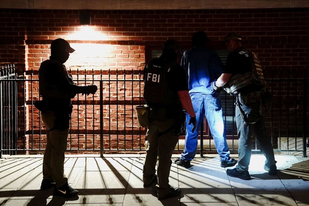 Members of the US Secret Service and FBI detain a man outside the New York Avenue Presbyterian Church in Washington, DC, on August 14, 2025.