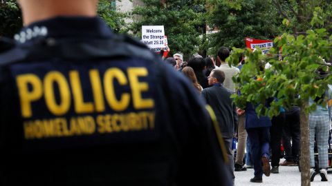 Homeland Security police officer stands behind a press conference called by Boston Mayor Michelle Wu to respond to a letter from US Attorney General Pam Bondi demanding that Boston change its immigration policies, in Boston, Massachusetts on August 19, 2025.