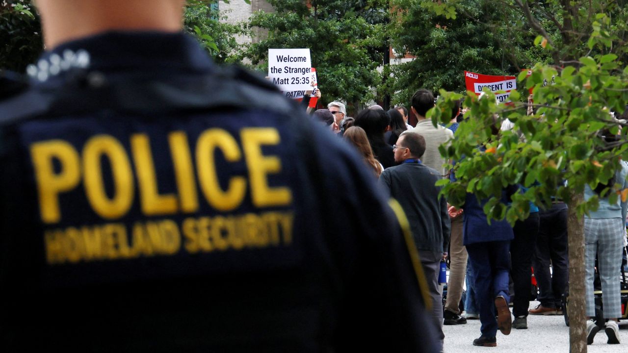 Homeland Security police officer stands behind a press conference called by Boston Mayor Michelle Wu to respond to a letter from US Attorney General Pam Bondi demanding that Boston change its immigration policies, in Boston, Massachusetts on August 19, 2025.