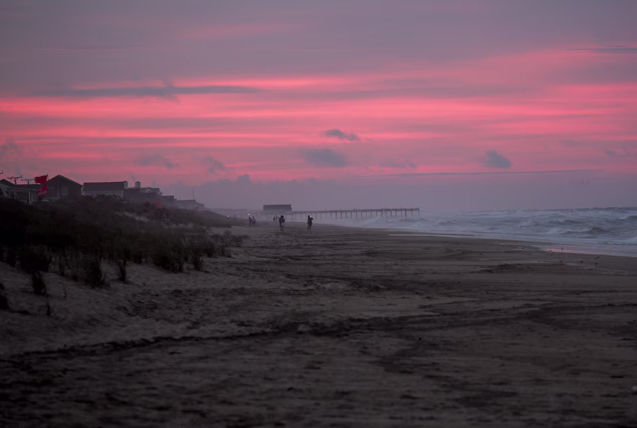 People look at the waves during sunset in Kitty Hawk on the Outer Banks, North Carolina, on Wednesday.