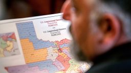 State Representative Matt Morgan holds a map of the new proposed congressional districts in Texas, at the Texas State Capitol in Austin, Texas, on August 20, 2025.