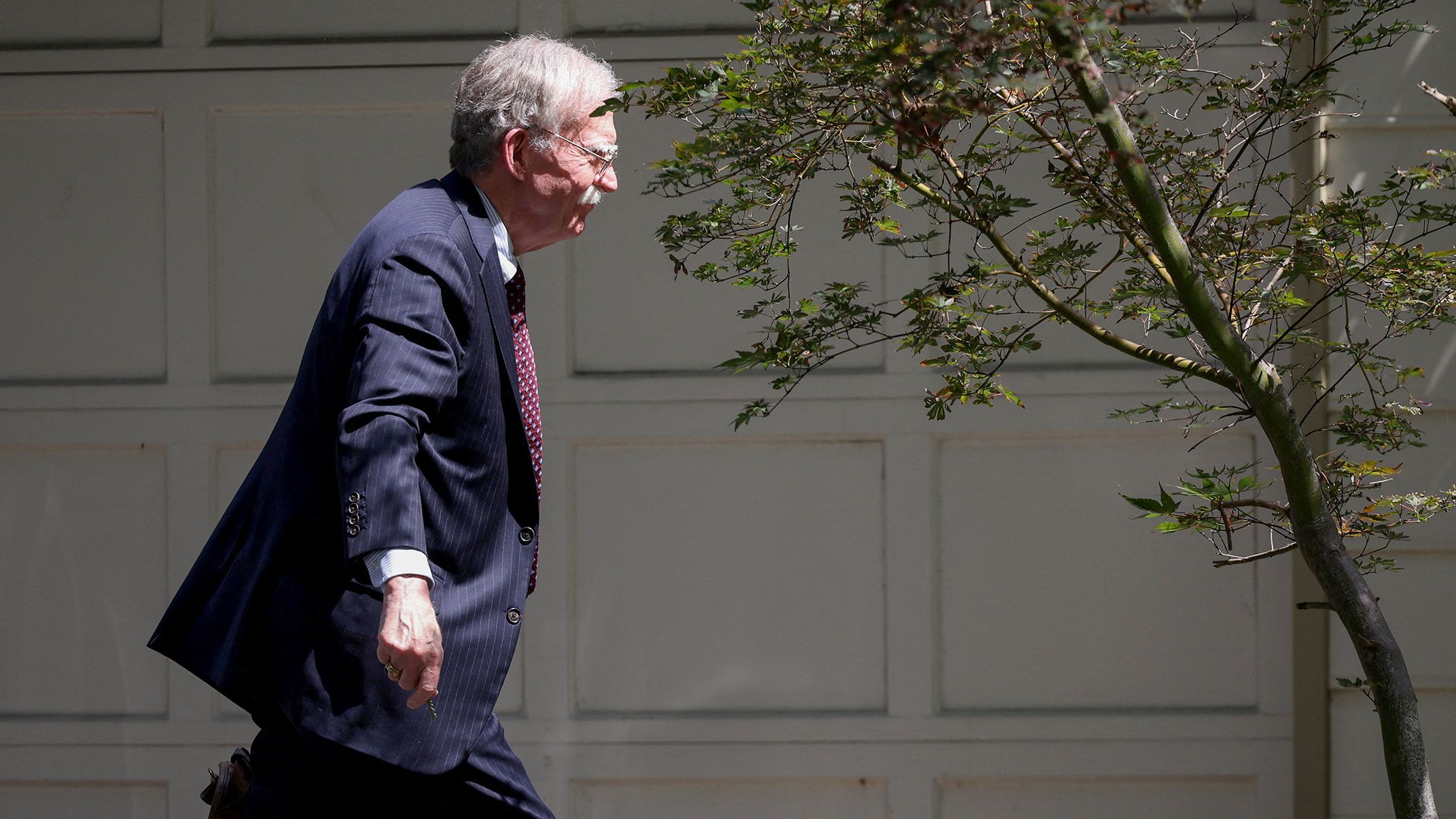 Former White House national security adviser John Bolton arrives at his house following its search by the FBI, in Bethesda, Maryland, U.S., August 22, 2025. REUTERS/Tasos Katopodis