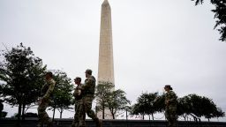 Members of the National Guard walk near the Washington Monument on the National Mall after U.S. President Donald Trump deployed the National Guard and ordered an increased presence of federal law enforcement to assist in crime prevention, in Washington, DC, on August 21, 2025.