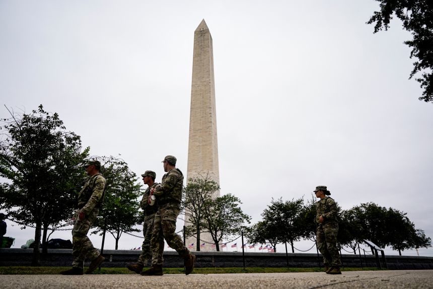 Members of the National Guard walk near the Washington Monument on the National Mall after U.S. President Donald Trump deployed the National Guard and ordered an increased presence of federal law enforcement to assist in crime prevention, in Washington, DC, on August 21, 2025.