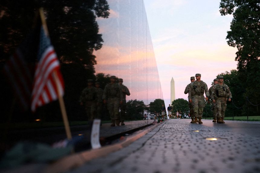 Members of the National Guard walk through the National Mall on Saturday in Washington, DC.