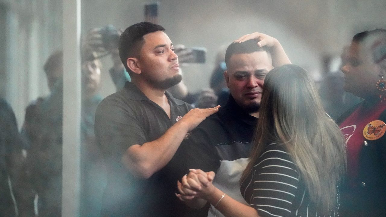 Kilmar Abrego Garcia, the migrant whose wrongful deportation to El Salvador made him a symbol of U.S. President Donald Trump's aggressive immigration policies, holds his wife Jennifer Vasquez Sura's hand, as he appears for a check-in at the ICE Baltimore field office three days after his release from criminal custody in Tennessee, in Baltimore, Maryland, U.S. August 25, 2025. Picture taken through glass.  REUTERS/Elizabeth Frantz