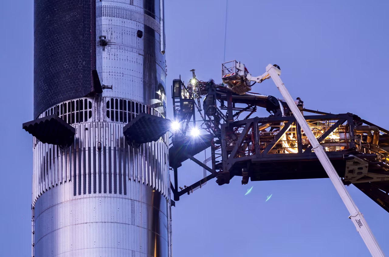 Technicians conduct work on Starship as SpaceX prepares for the launch attempt near Brownsville, Texas, on Monday.