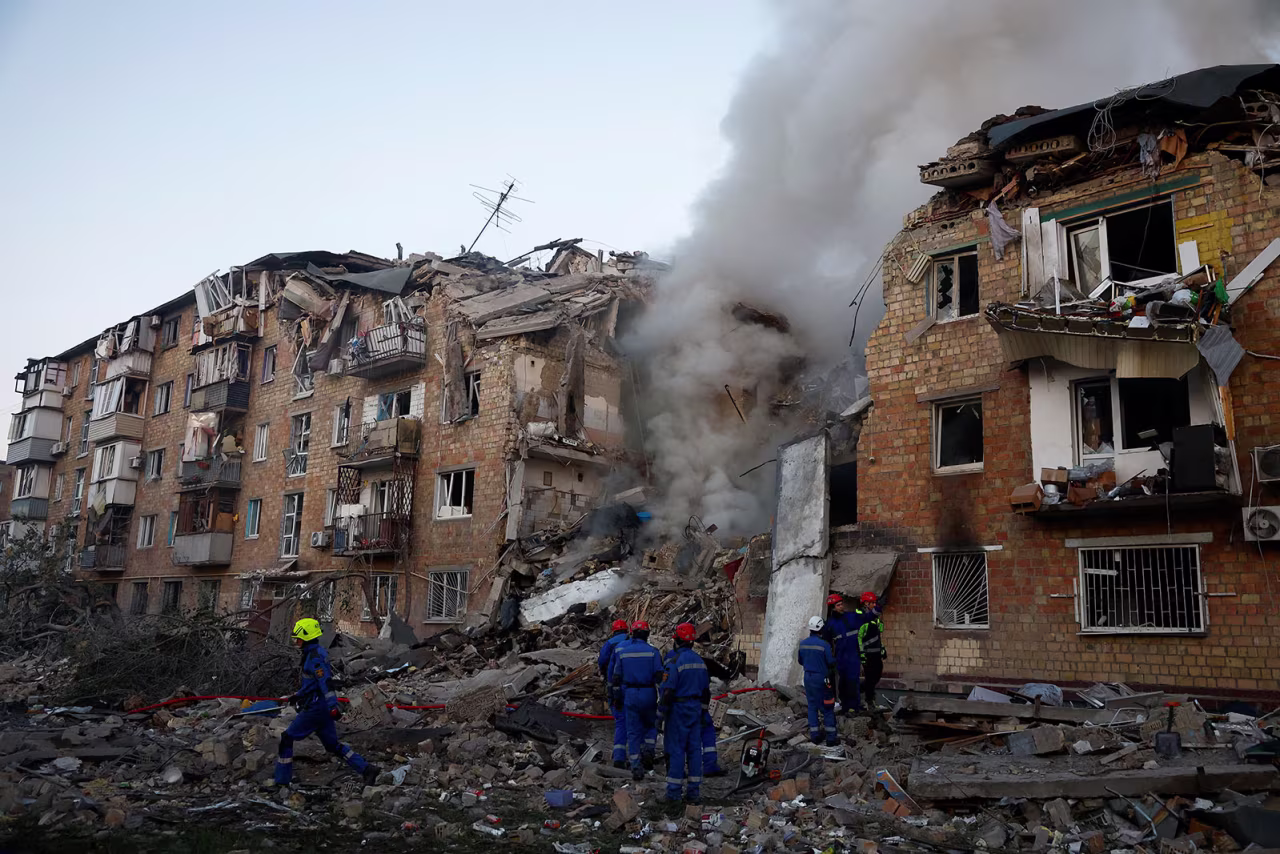 Rescuers work at the site of a building in Kyive, Ukraine, which was hit by Russian missile and drone strikes on Thursday.