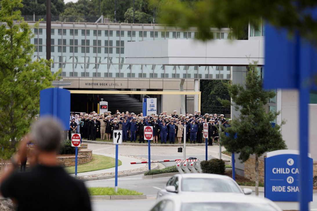 Members of the US Public Health Service Commissioned Corps salute the former officials Wednesday afternoon as staffers gathered outside the CDC's main campus in Atlanta.