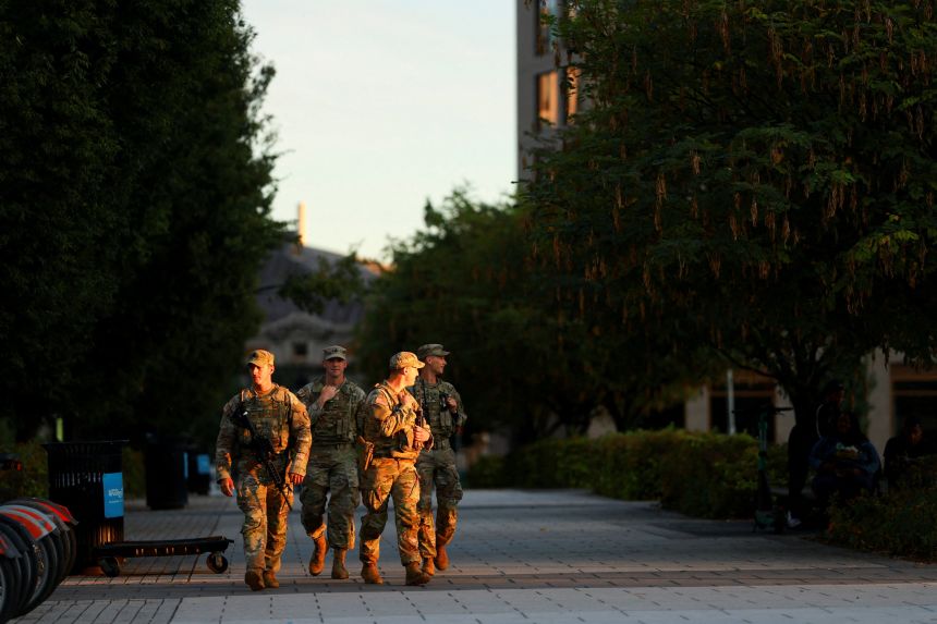 Members of the West Virginia National Guard carry firearms while patrolling at the Navy Yard in Washington, DC, on Sunday.