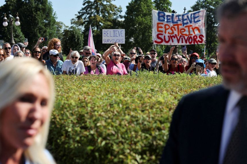 People shout on the sidelines of a press conference to discuss the Epstein Files Transparency bill, on Capitol Hill on Wednesday.