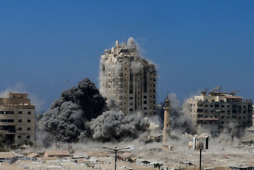 Smoke rises as the building hits an Israeli strike in Gaza city on Friday.