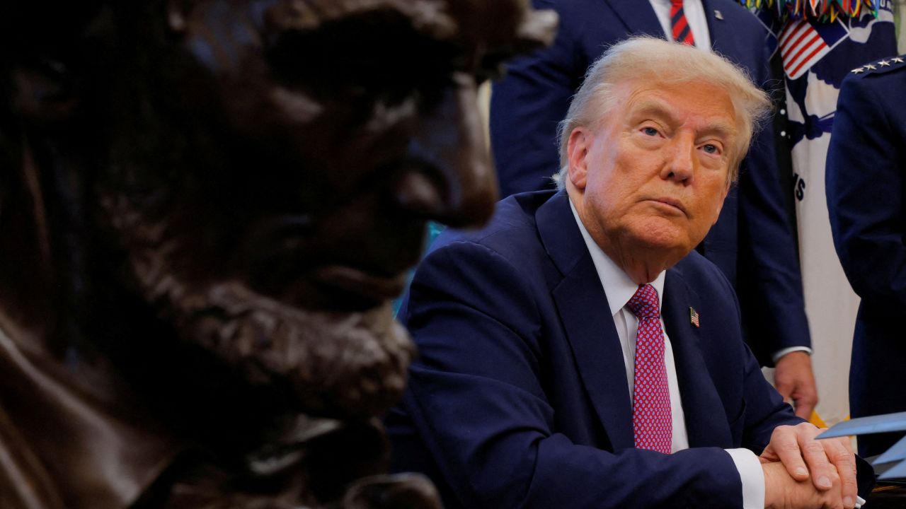 U.S. President Donald Trump speaks with the media on the day of the signing of an executive order to rename the Department of Defense the "Department of War", with the bust of Abraham Lincoln in the foreground, in the Oval Office, at the White House in Washington, D.C., U.S., September 5, 2025. REUTERS/Brian Snyder      TPX IMAGES OF THE DAY
