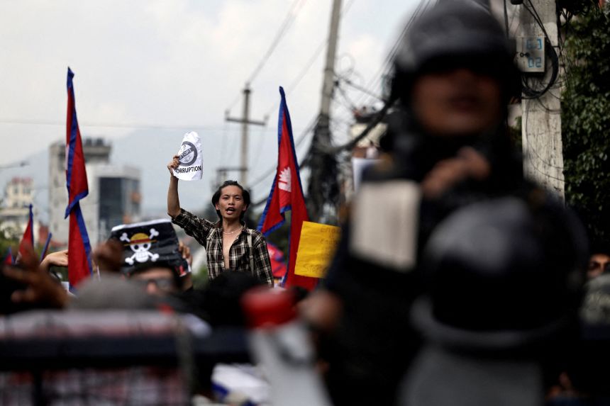 A demonstrator shouts slogans during a protest against corruption in Kathmandu, Nepal on Monday.