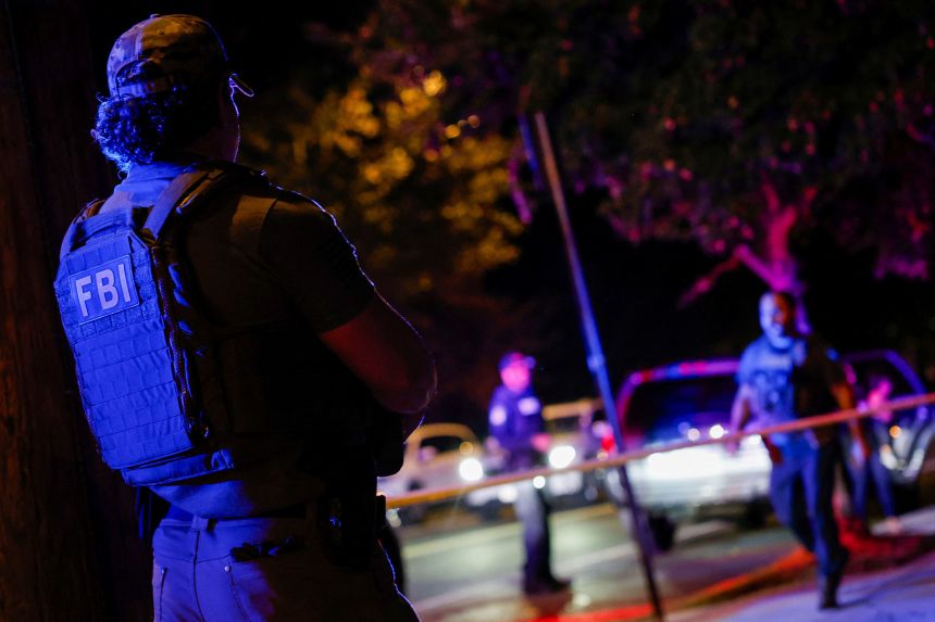 An FBI agent assists Metropolitan Police and US Customs and Border Protection om the detention of a man in Washington, DC, on Monday night.