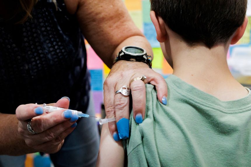 A child receives a dose of the Covid-19 vaccine in Schwenksville, Pennsylvania, on September 11, 2025.