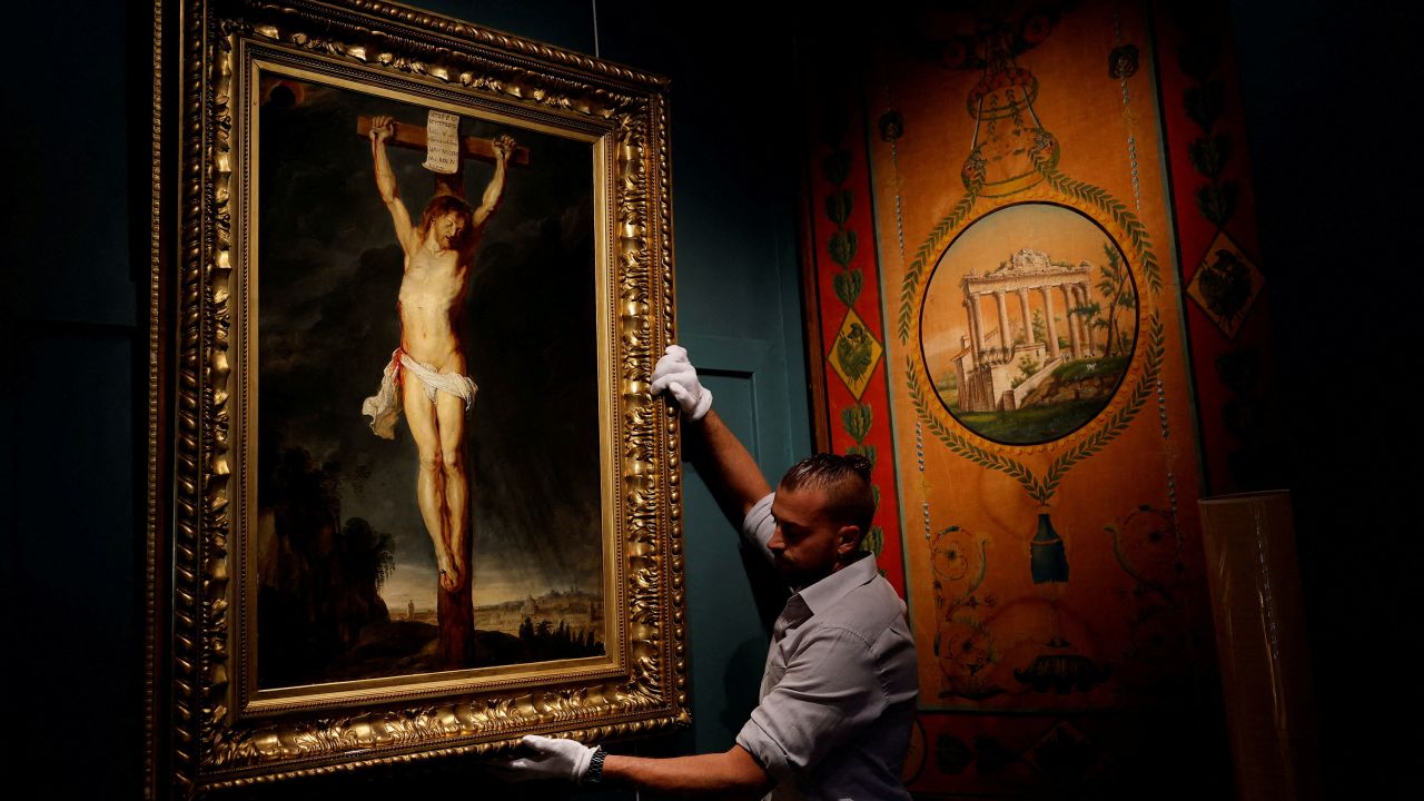 The painting "Christ on the Cross" is pictured on display in Paris prior to the auction.